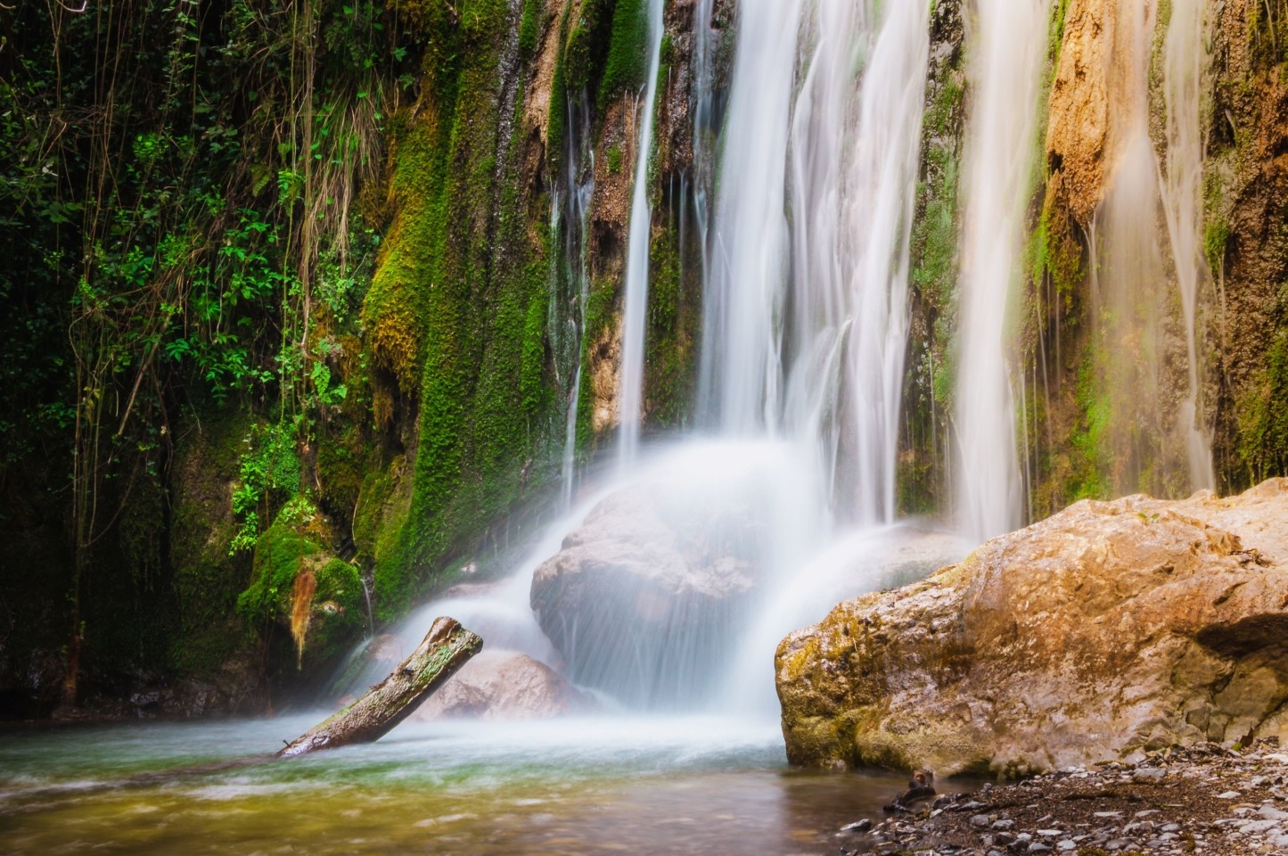 Waterfall in Valle delle Ferriere nature reserve near Amalfi surrounded by lush green vegetation