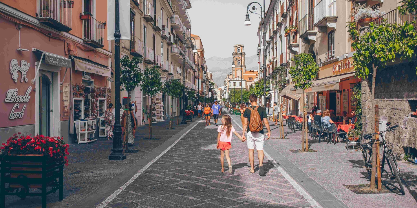 Famiglia che passeggia tra le strade del centro storico di Sorrento durante una gita in famiglia.