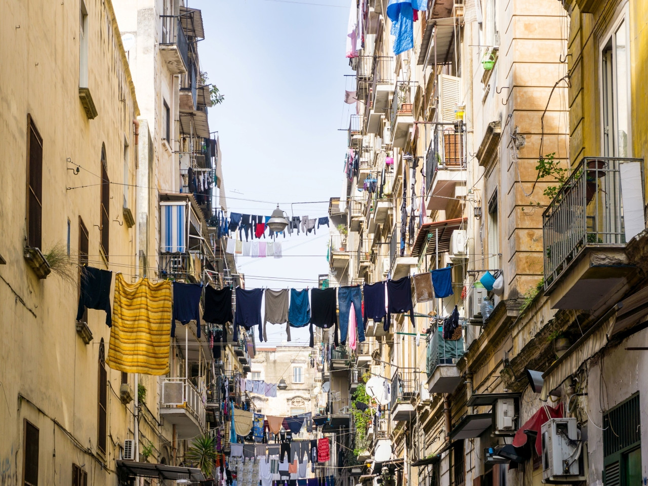 Narrow street in Naples Spanish Quarters with hanging laundry and balconies