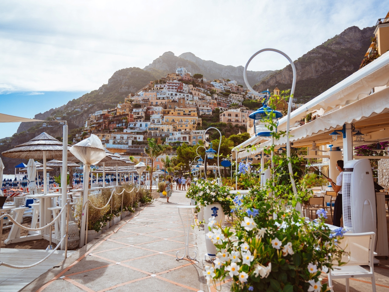 Seaside walkway in Positano with beach clubs and coastal view