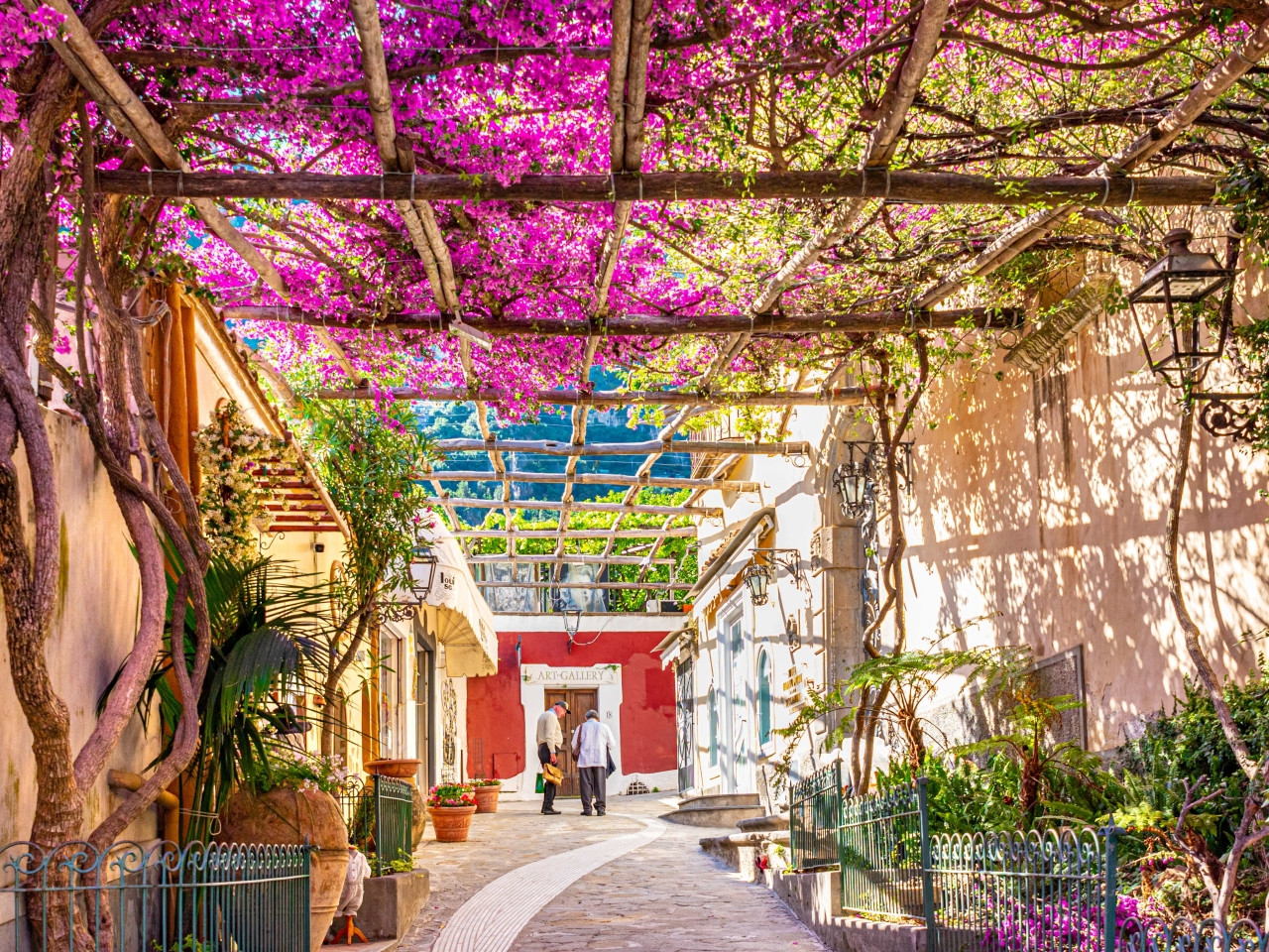 Charming street in Positano with bougainvillea flowers and shaded walkway