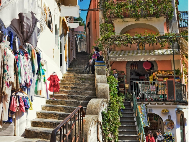 Positano narrow stairs with local shops and colorful buildings along the Amalfi Coast