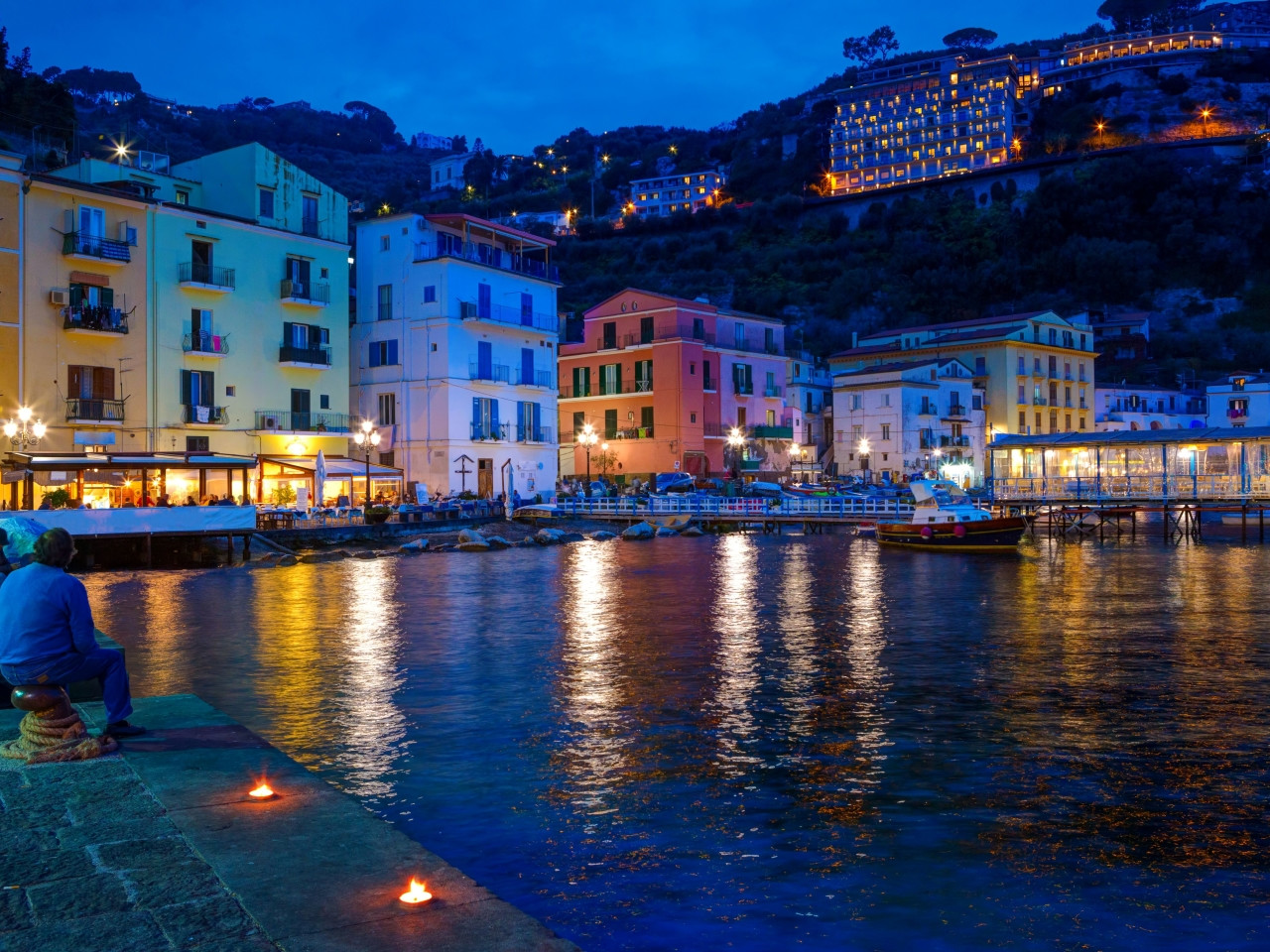 Night view of Marina Grande in Sorrento with lights reflecting on the sea