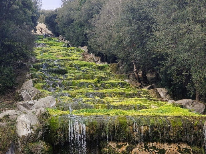 The waterfall in the park of the Royal Palace of Caserta, between terraced greenery and falling water