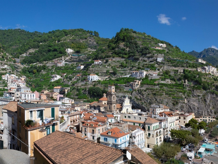 Panoramic aerial view of Minori on the Amalfi Coast with beach, colorful houses and terraced mountains