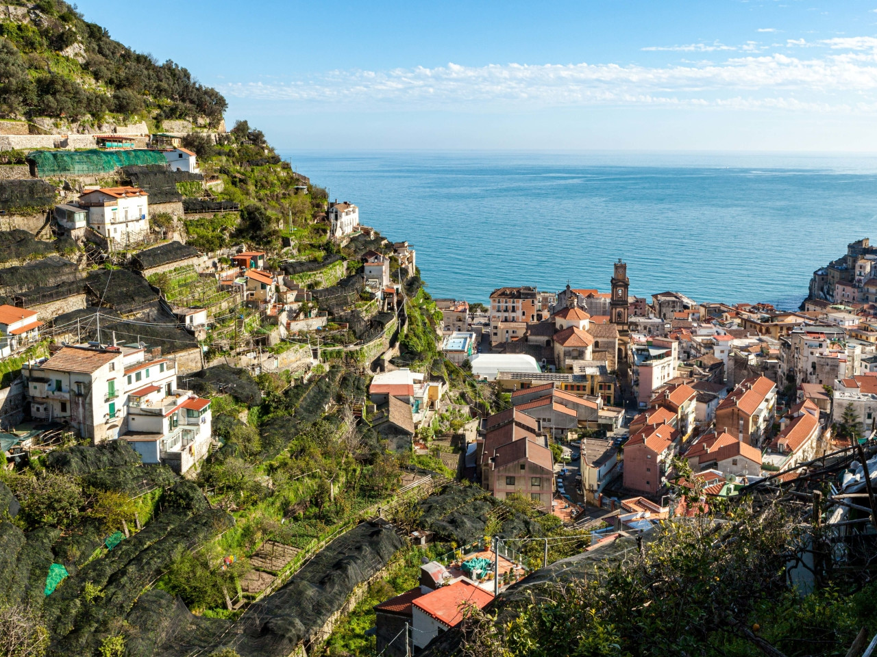 View of Minori historic center with bell tower and sea in the background on the Amalfi Coast