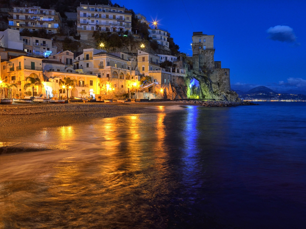 Night view of Cetara seafront with the illuminated Viceregal Tower