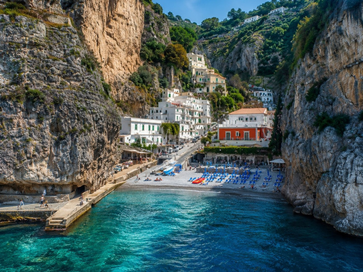 Marina di Praia in Praiano, with clear water and houses set into the cliffs