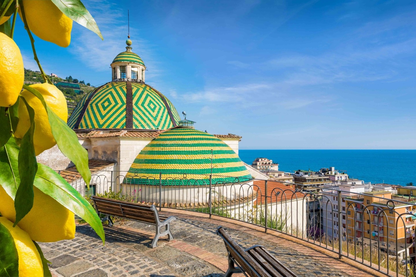 Church of Santa Maria a Mare in Maiori with colorful tiled dome and Amalfi Coast sea view.