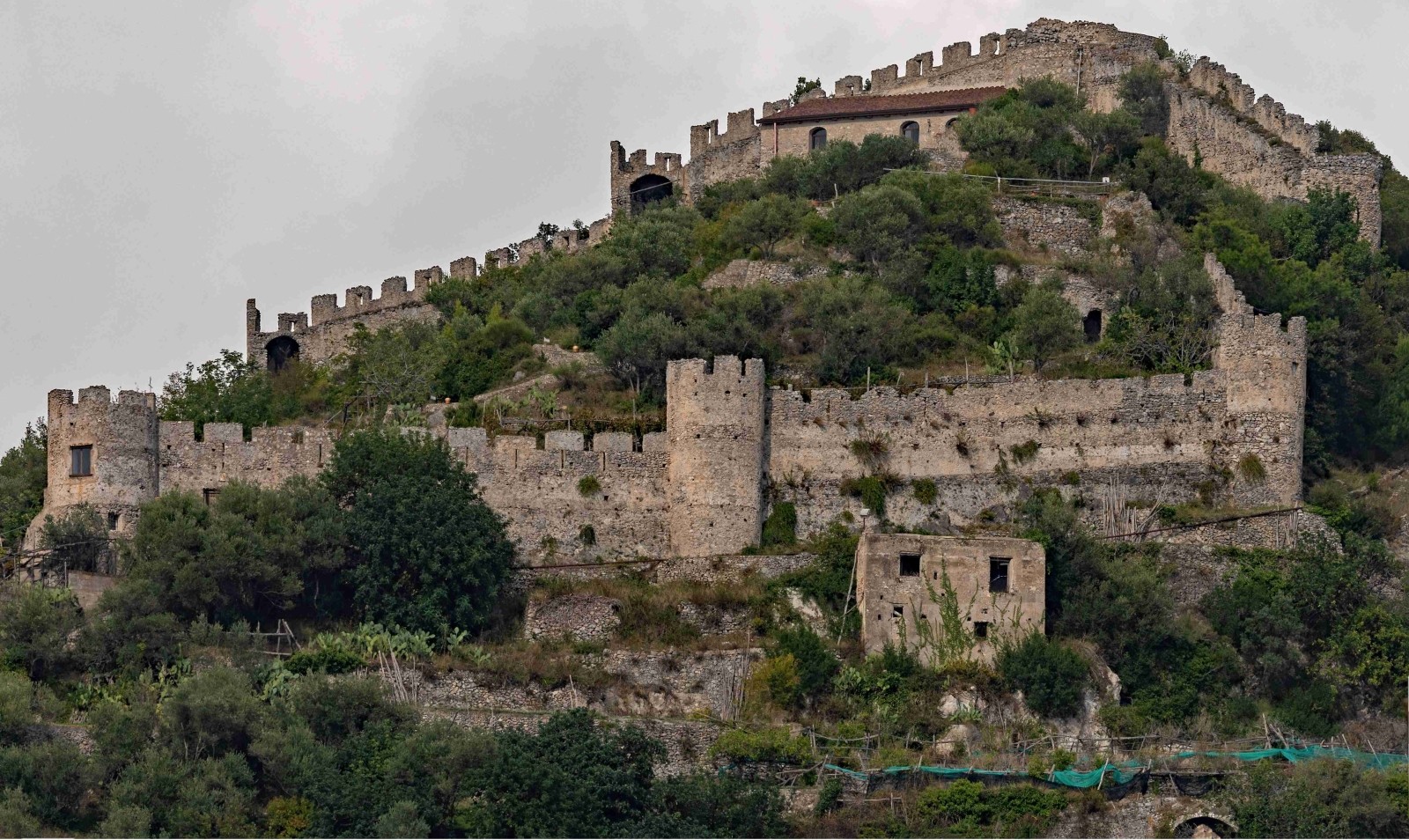 Ancient stone walls and towers of the Castle of San Nicola de Thoro-Plano on a hillside in Maiori.