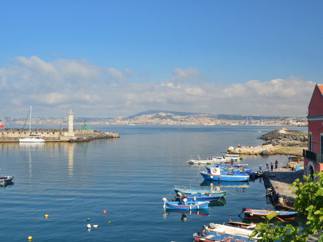 The harbour of Portici with moored boats and Vesuvius behind